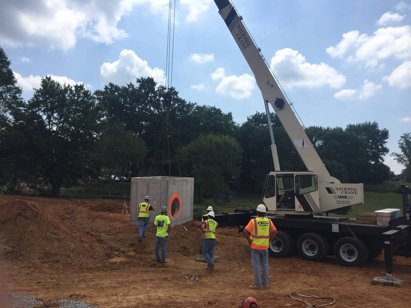 Crew setting a concrete culvert
